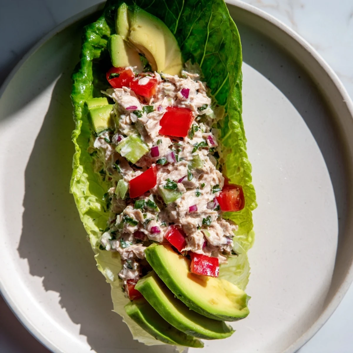 Quick & Healthy Tuna Salad Lettuce Wraps, featuring creamy tuna filling nestled in crisp romaine lettuce with avocado.
