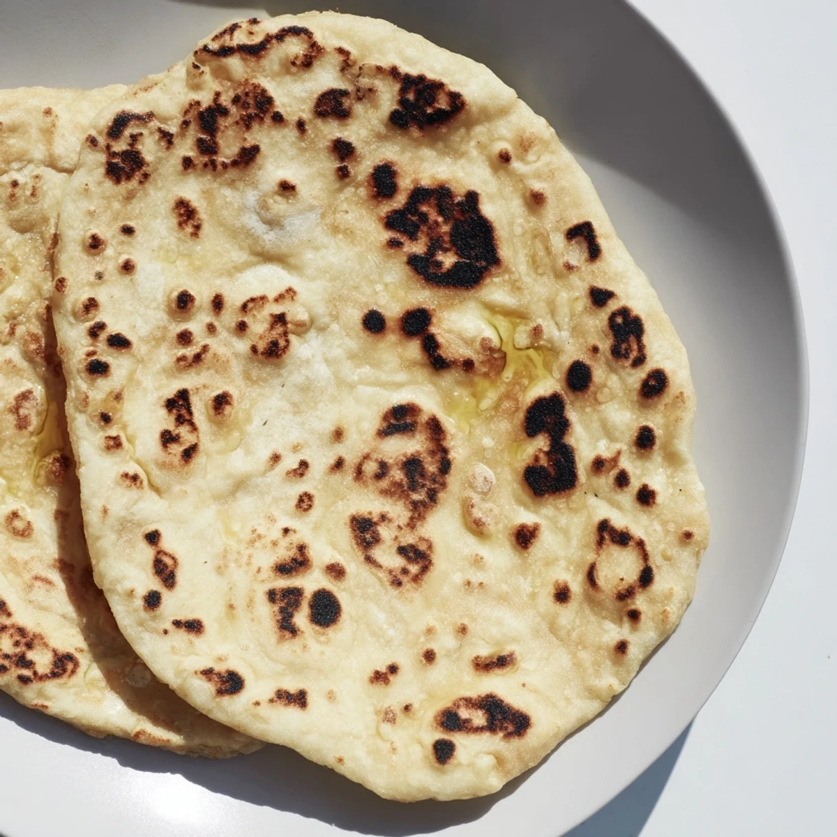 Golden-brown Three-Ingredient Easy Flatbreads, ready to be ripped and dipped in creamy hummus.