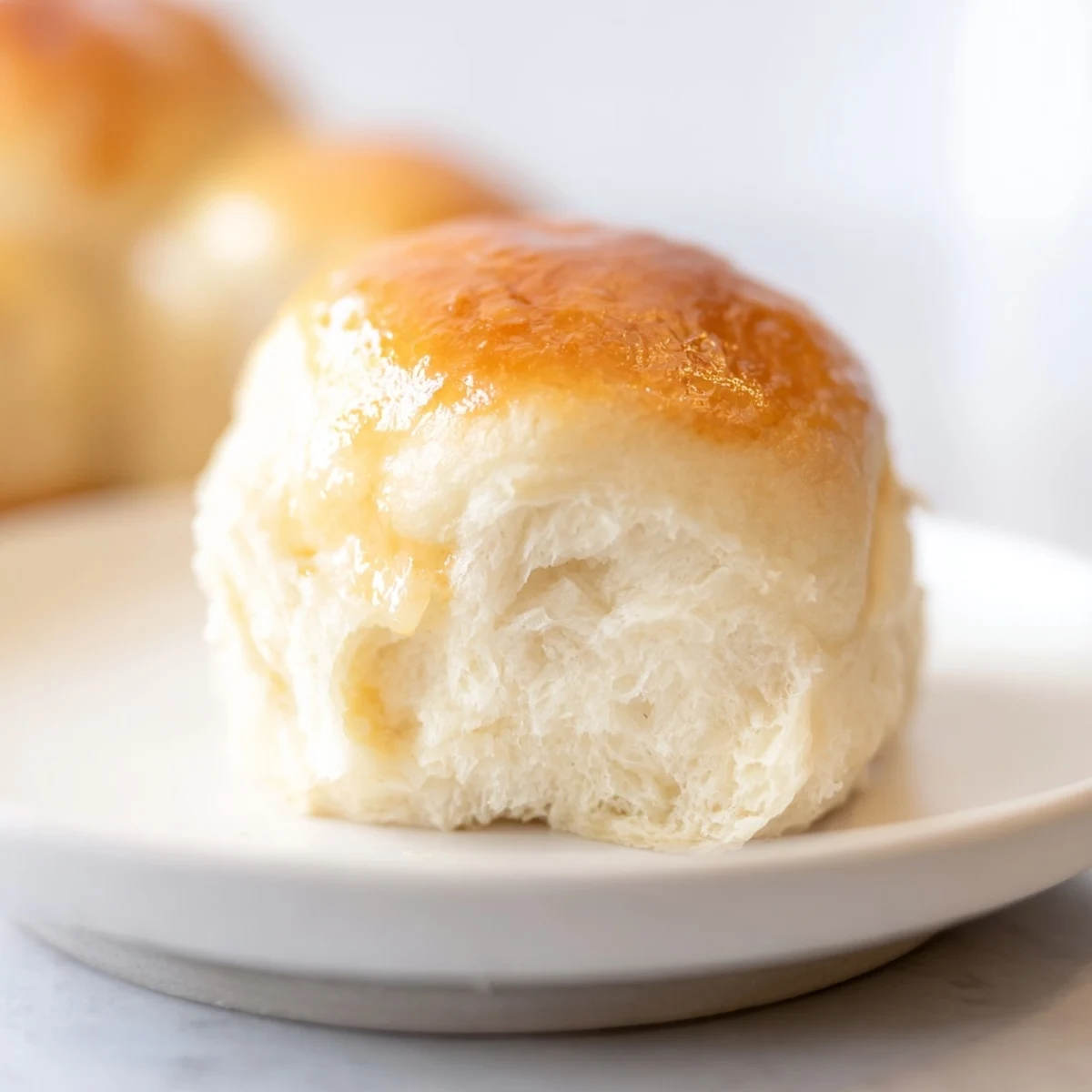 Golden Quick-Rise Dinner Rolls, fresh from the oven, with a buttery, inviting aroma and soft texture.