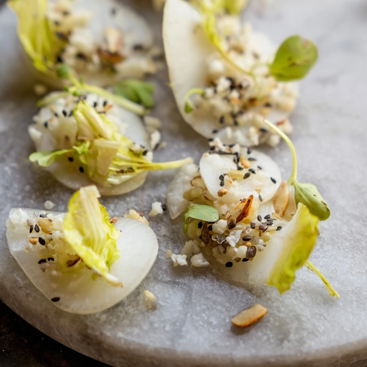 A chilled stone plate holds The Tundra Trek, featuring thinly sliced vegetables and flavorful accents.