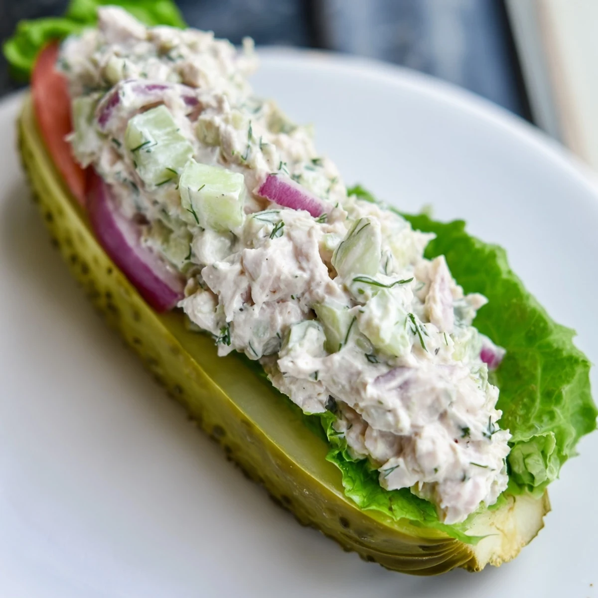 Cool and refreshing pickle sandwich with vibrant tomato and creamy chicken salad filling.