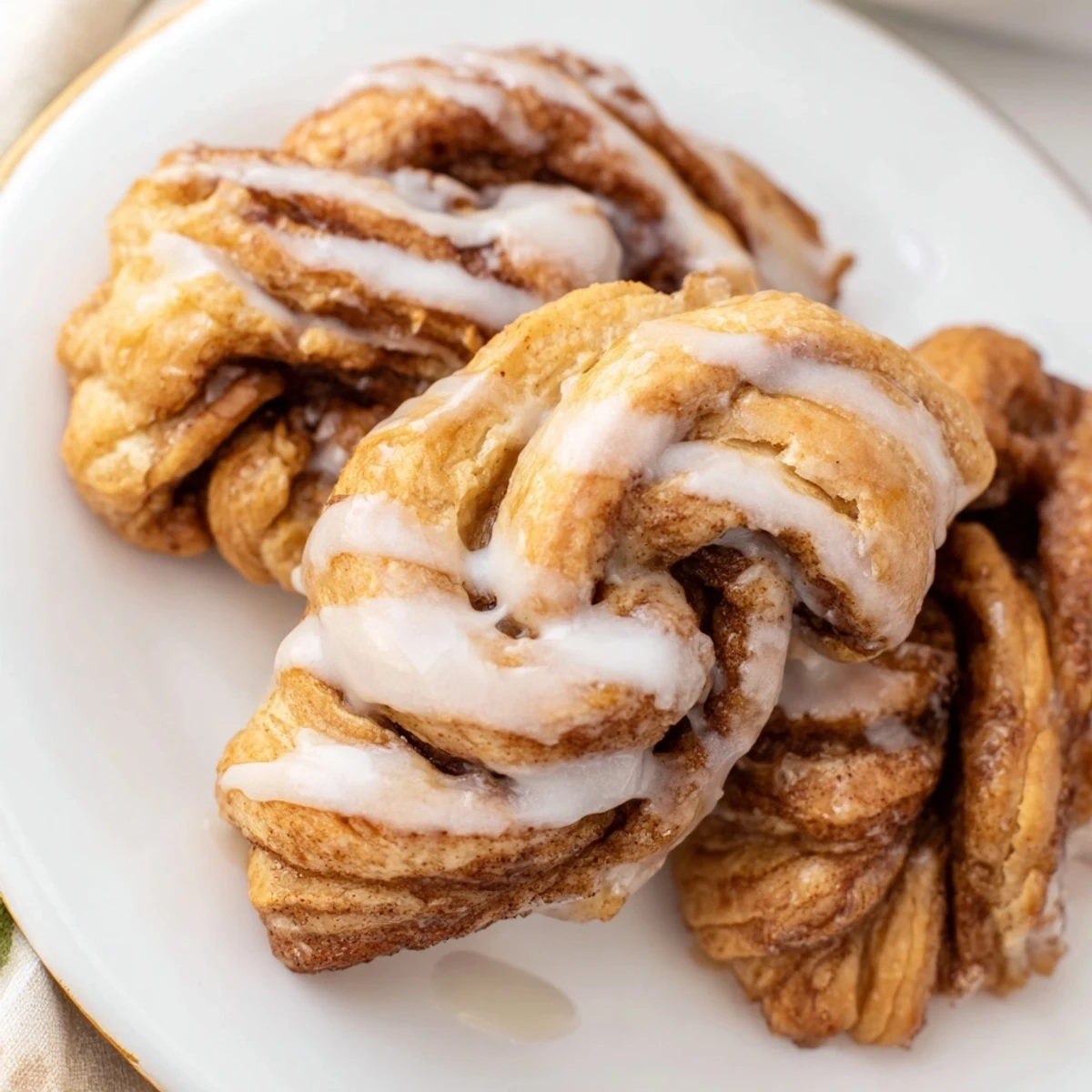 Close-up of freshly made air fryer cinnamon roll twists, offering a delightful aroma and texture.