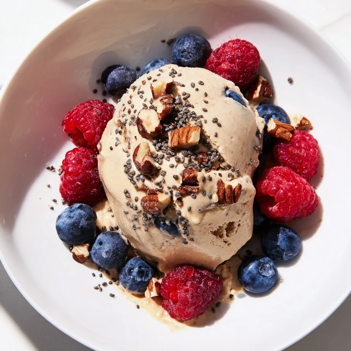 Creamy Protein Ice Cream Bowl with fresh berries visually enticing, a healthy treat for the summer.