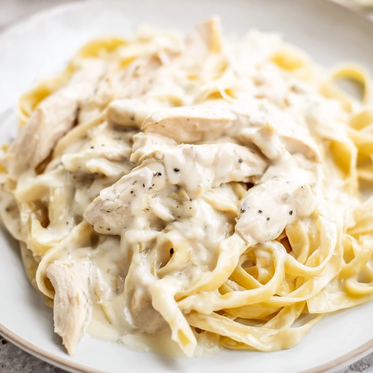 Golden-brown skillet chicken strips nestle in a rich, creamy Alfredo sauce, generously tossed with al dente fettuccine for an easy weeknight dinner.  