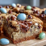 Peanut Butter Easter Egg Cookie Bars with colorful candy eggs and gooey chocolate chips on a baking tray.