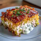 Cheesy Hash Brown Casserole with golden cornflake topping, bubbling and hot from the oven.