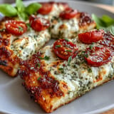 Delicious cottage cheese flatbread, golden baked with fresh pesto and tomatoes.