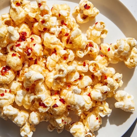 Golden, glistening Hot Honey Butter Popcorn with a balanced sweet, spicy, and savory aroma.