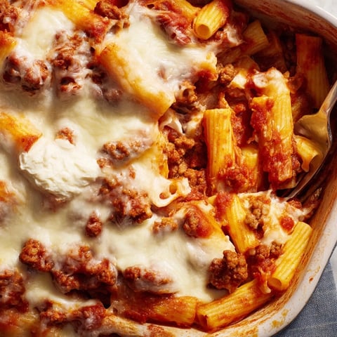 Golden bubbly Freezer Make-Ahead Baked Ziti topped with melted mozzarella, served with a simple green salad.