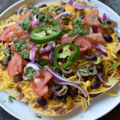 Golden, bubbly Sheet Pan Nachos, generously loaded and ready to be served hot from the oven.