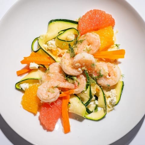 Vibrant The Coral Reef recipe features pink shrimp and citrus with browned Gruyère, a flavorful dinner.