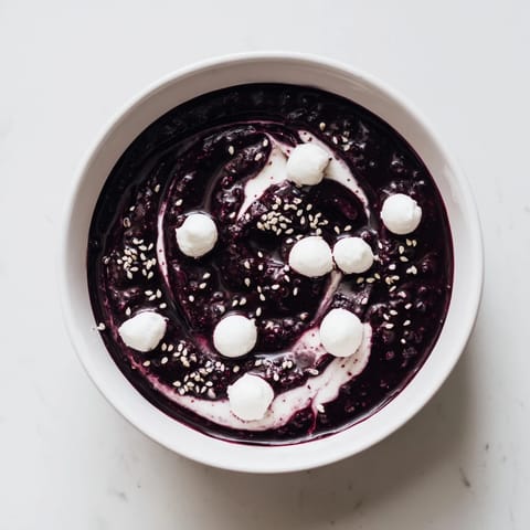 Enjoy a beautiful Galaxy Spiral, featuring creamy yogurt, dark jam spirals, and sesame seed starbursts, ready in minutes.