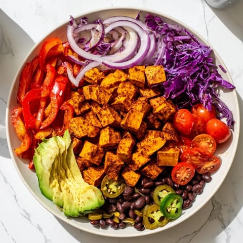A visually appealing Sweet Potato Taco Bowl with vibrant roasted vegetables and a zesty lime dressing, ready to eat.