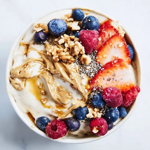 A close-up of a Protein Ice Cream Bowl showing the vibrant colors from fresh toppings.