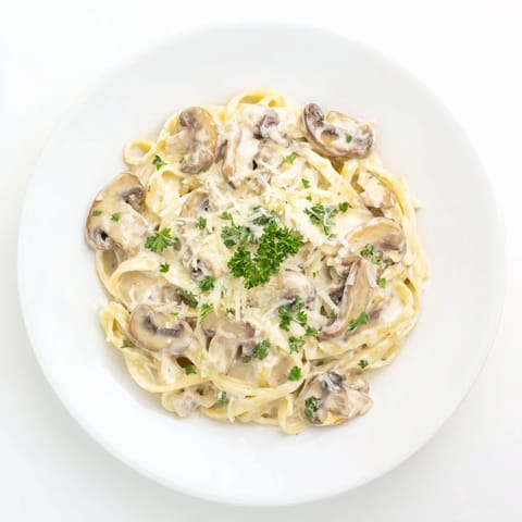 Sautéed golden cremini mushrooms and minced garlic simmer in rich cream, tossed with al dente pasta and finished with nutmeg for a velvety texture.