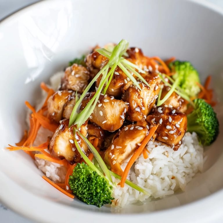 Steaming, delightful 20-minute chicken teriyaki bowls, topped with sesame seeds and green onions for extra flavor.