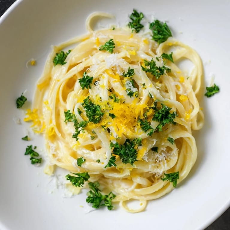 A bowl overflowing with Lemon-Garlic Greek Yogurt Pasta, a quick, fresh meal bursting with Mediterranean flavors.