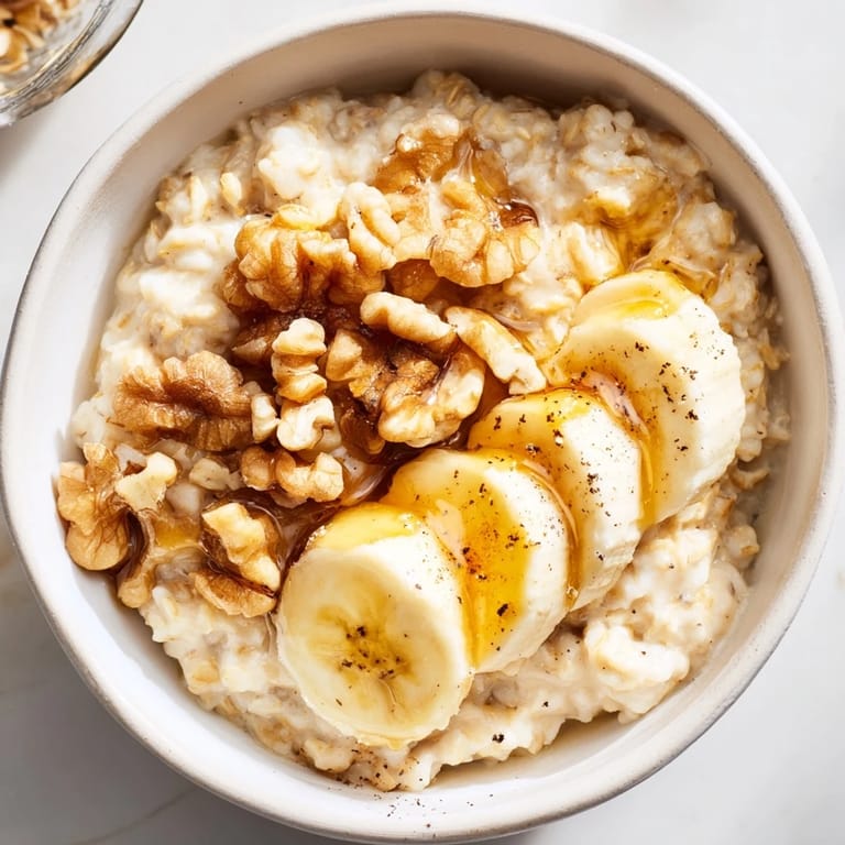 Close-up of a cozy, creamy Microwave Banana Oats breakfast bowl topped with fresh banana slices.
