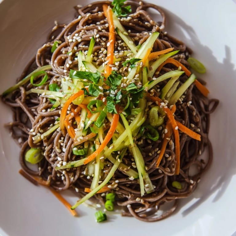 Vibrant Chilled Noodle Lunch Cups, featuring cool noodles, are garnished with fresh cilantro and crunchy carrots.