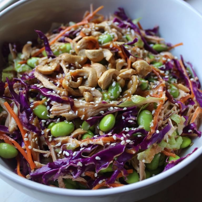 Edamame Crunch Chicken Salad featuring tender shredded chicken, fresh edamame, and colorful vegetables drizzled in ginger dressing.  