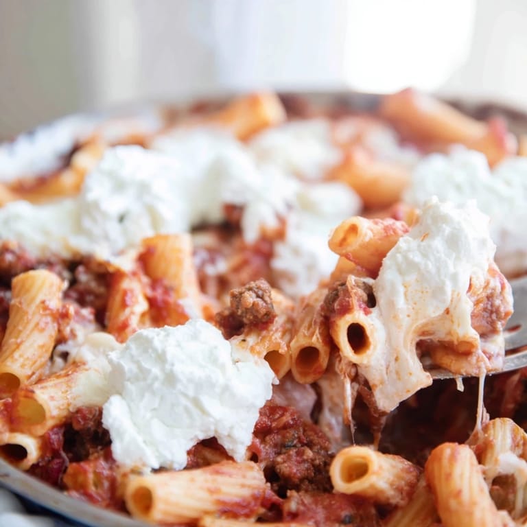 Family-style Freezer Make-Ahead Baked Ziti baked in a dish, ready to serve with garlic bread.