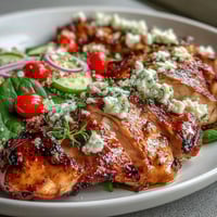 Grilled chicken and veggie bowl with zesty lemon vinaigrette, fresh greens, and quinoa for a healthy, vibrant meal.