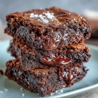 Rich tahini chocolate brownies with a marbled swirl of nutty tahini and fudgy dark chocolate, baked to perfection in a square pan.  